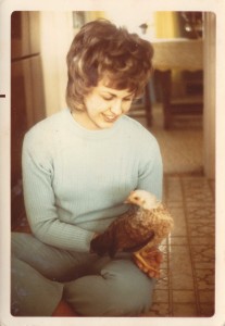 Mom holding a "teenage" chicken - in our kitchen!